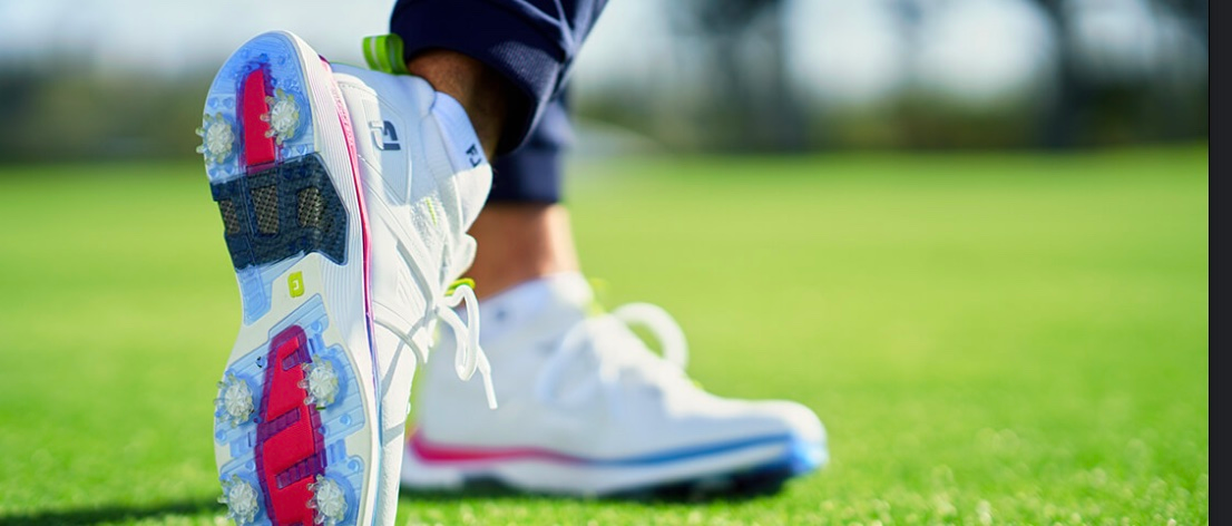 A pair of golf shoes on a golf course