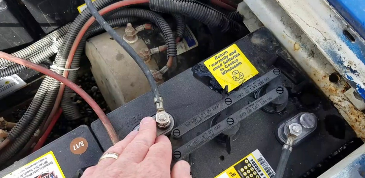 Image of a person installing a golf cart battery