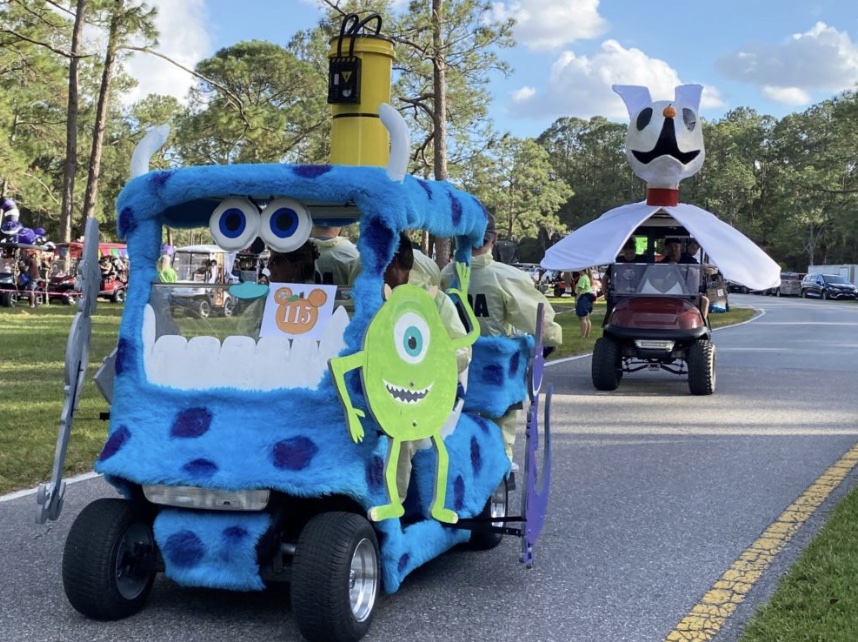 A golf cart decorated with crafts and other decorations for a parade