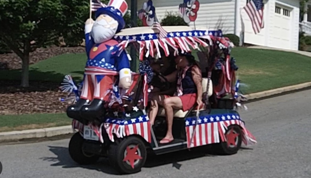 A golf cart decorated for the 4th of July with red, white and blue decorations