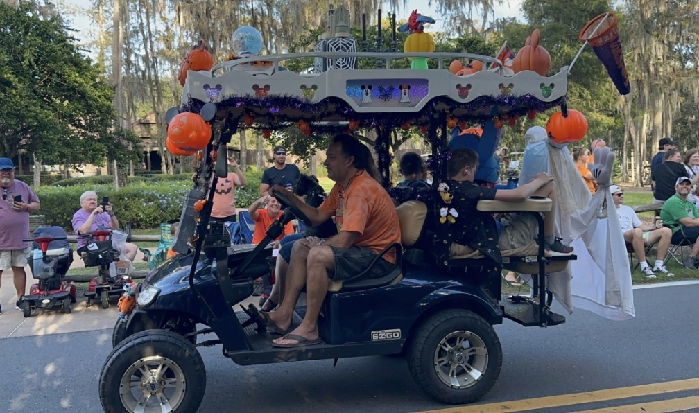 A golf cart decorated with accessories for a parade
